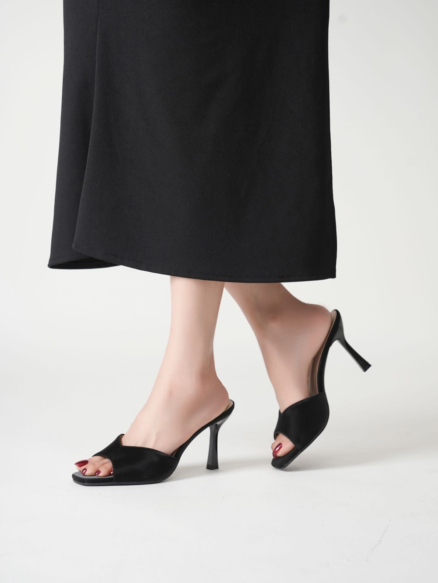 Mescini black wide band square toe mules worn with a long dark skirt, walking, US women's sizes