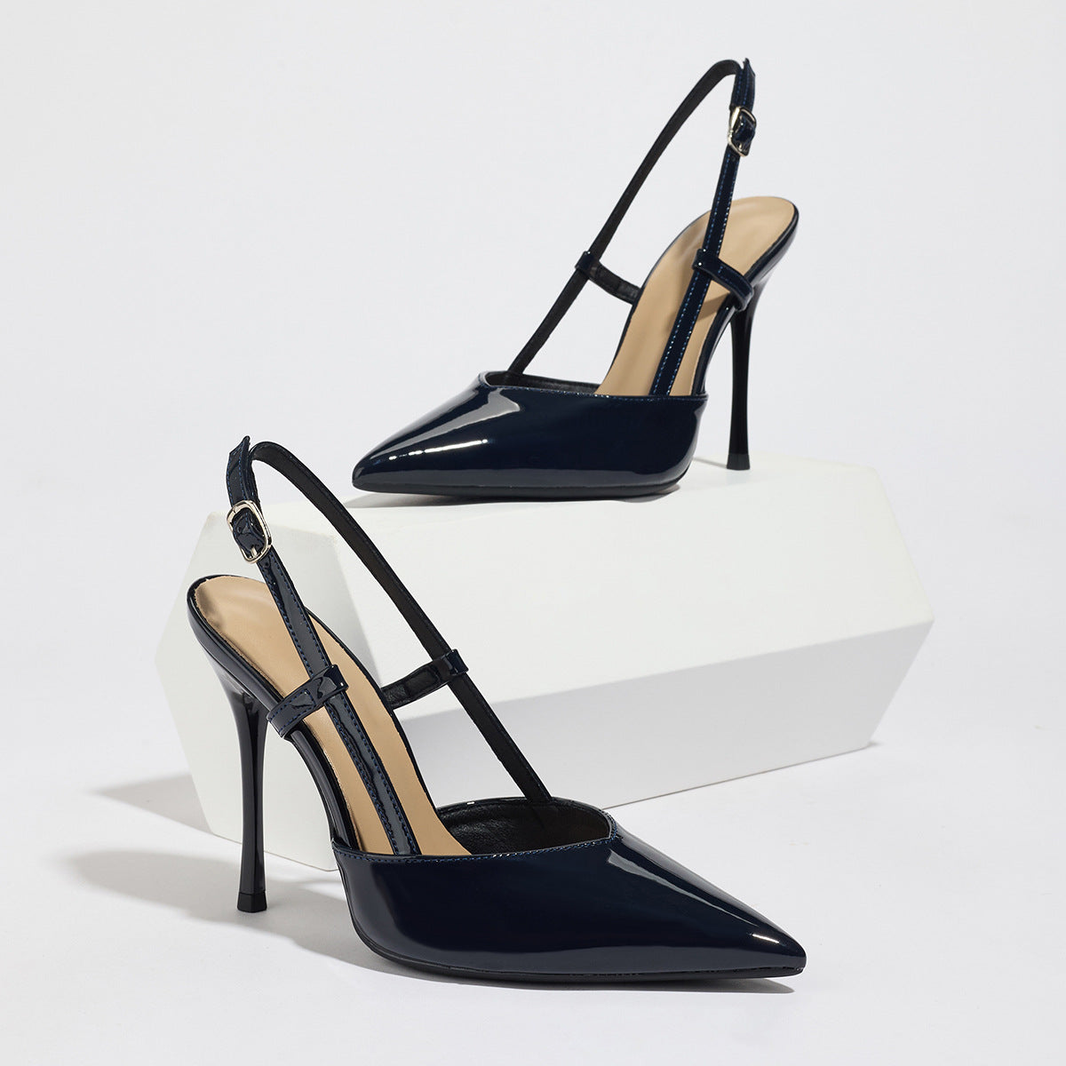 Mescini black patent pointed toe slingback heels, angled pair on a white block, US women's sizes