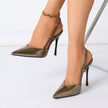 Mescini – bronze pointed toe slingback stiletto heels worn on both feet, US women's sizes