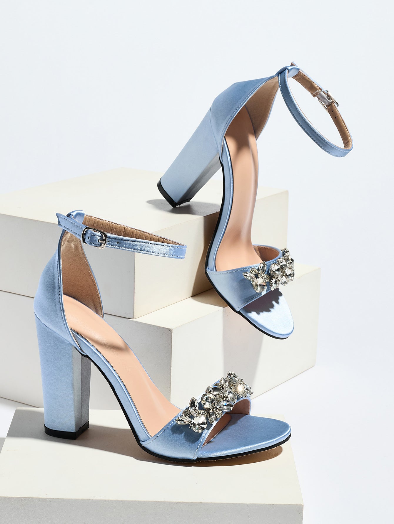 Mescini light blue crystal strap block heel sandals, pair posed on white display blocks, US women's sizes
