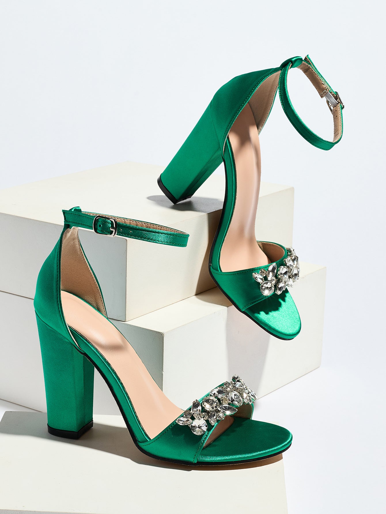 Mescini green crystal strap block heel sandals, pair set on white display blocks, US women's sizes