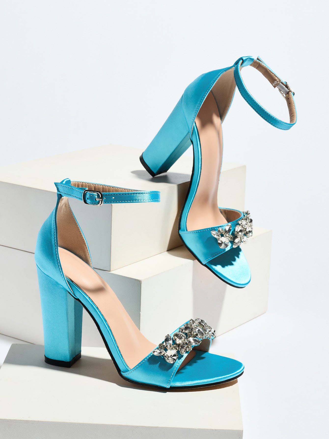 Mescini sky blue crystal strap block heel sandals, pair posed on white blocks, US women's sizes