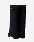 Mescini black fold over knee high boots, worn by a model seated on a bench, US sizes