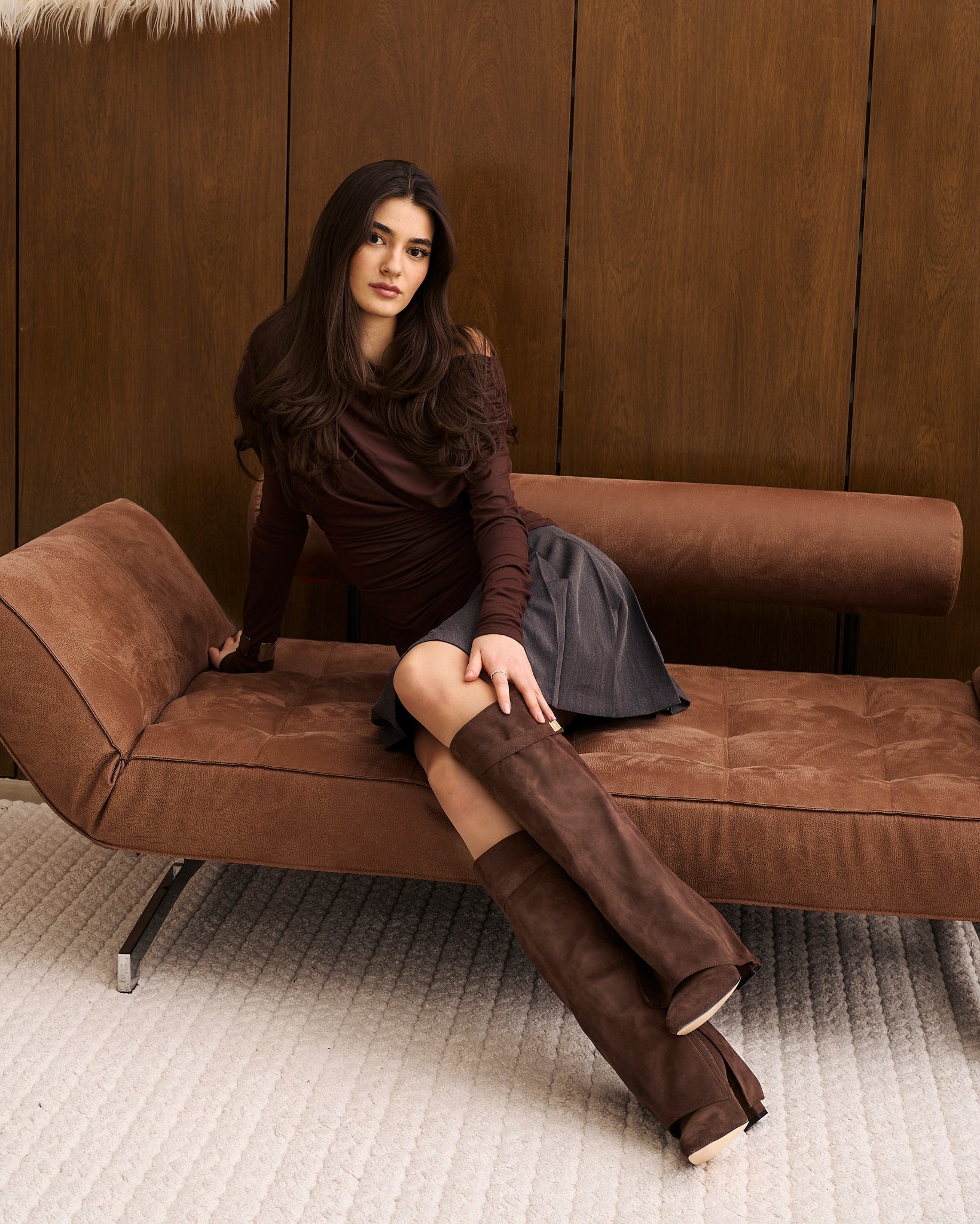 Mescini dark brown fold over knee high boots, worn by a model seated on a bench, US sizes