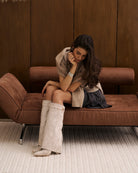 Mescini taupe fold over knee high boots, worn by a model seated on a bench, US sizes
