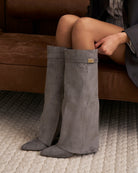 Mescini grey fold over knee high boots, angled pair view on a pale floor, US sizes