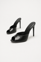 Mescini black sculpted peep toe stiletto mules, angled pair on a pale studio backdrop, US women's sizes