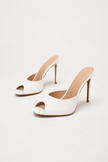 Mescini white sculpted peep toe stiletto mules, angled pair on an ivory background, US women's sizes