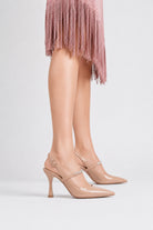 Mescini nude crystal strap pointed slingback pumps, worn on the model standing on white, US women's sizes