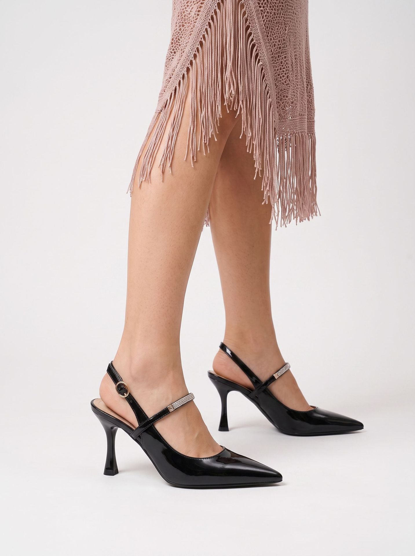 Mescini black crystal strap pointed slingback pumps, worn on the model standing, close view, US women's sizes