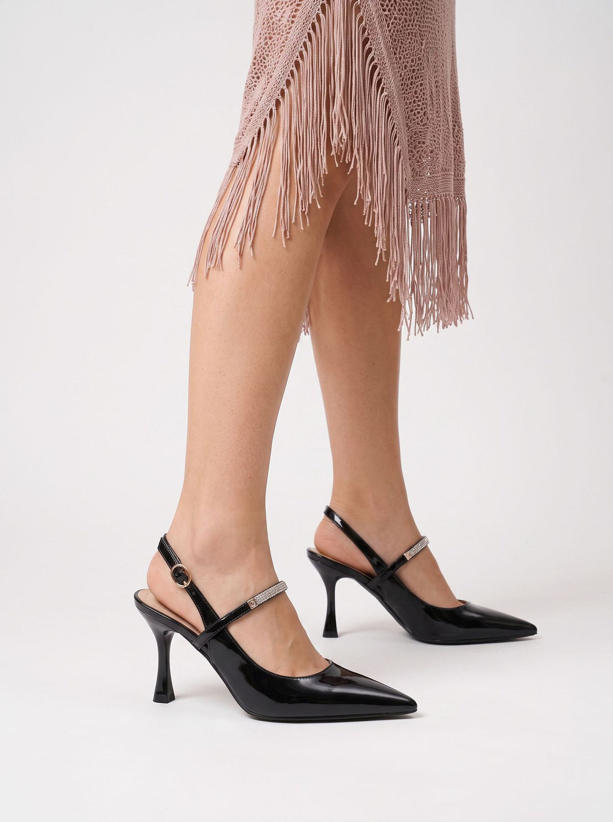 Mescini black crystal strap pointed slingback pumps, worn on the model standing, close view, US women's sizes