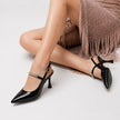 Mescini – black pointed toe slingback pumps with crystal strap, worn view, US women's sizes