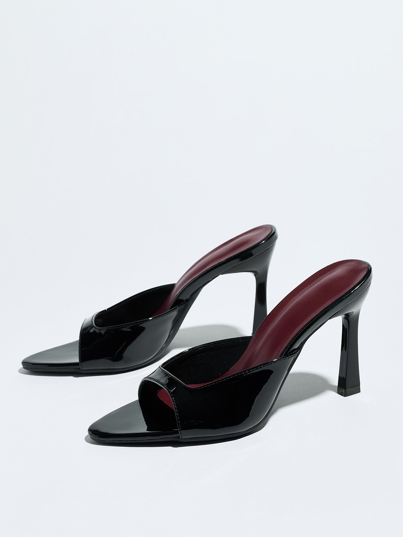 Mescini black square open toe stiletto mules, pair angled on a pale grey background, US women's sizes