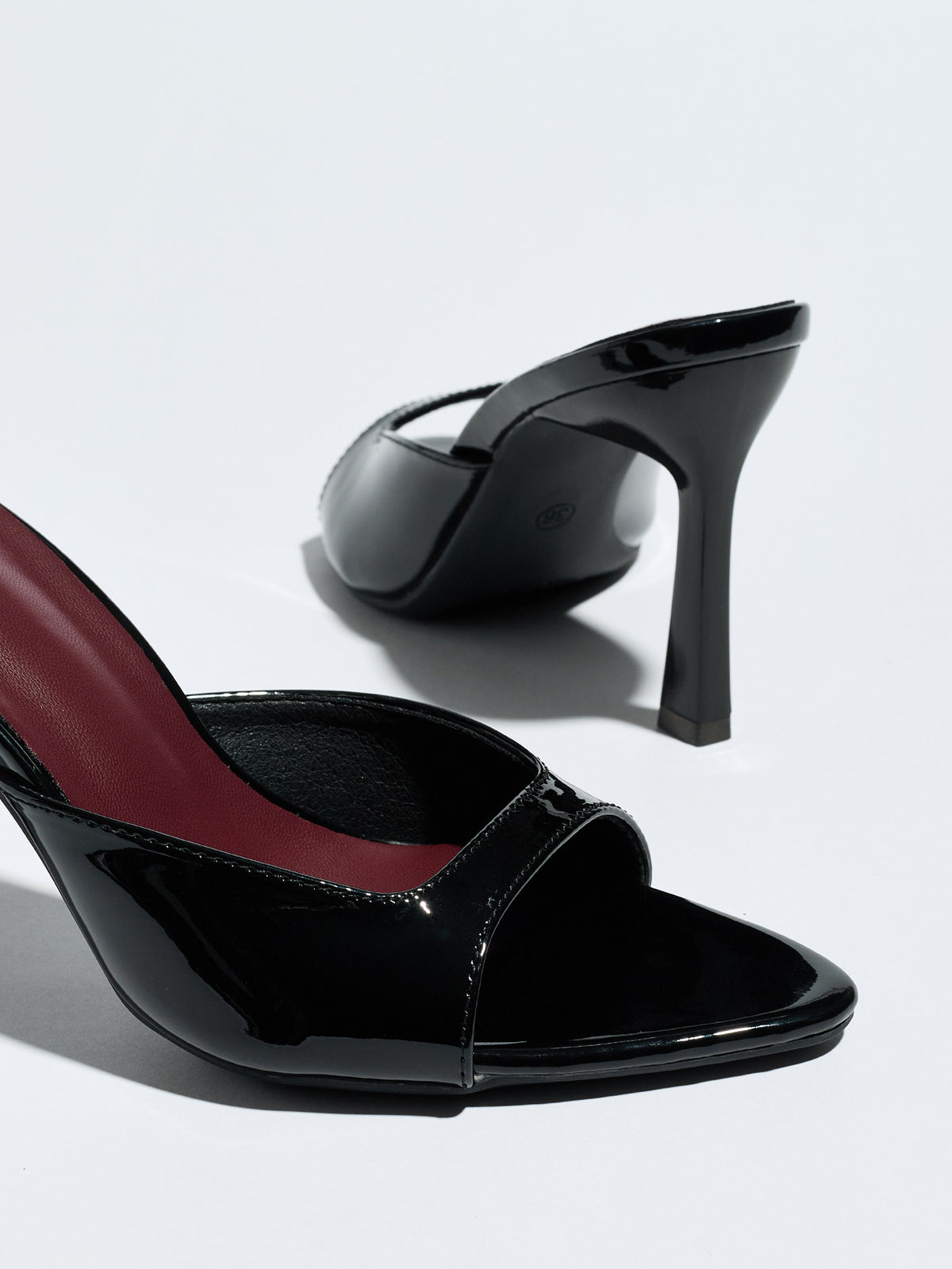 Mescini black square open toe stiletto mules, close up with one shoe lying on its side, US women's sizes