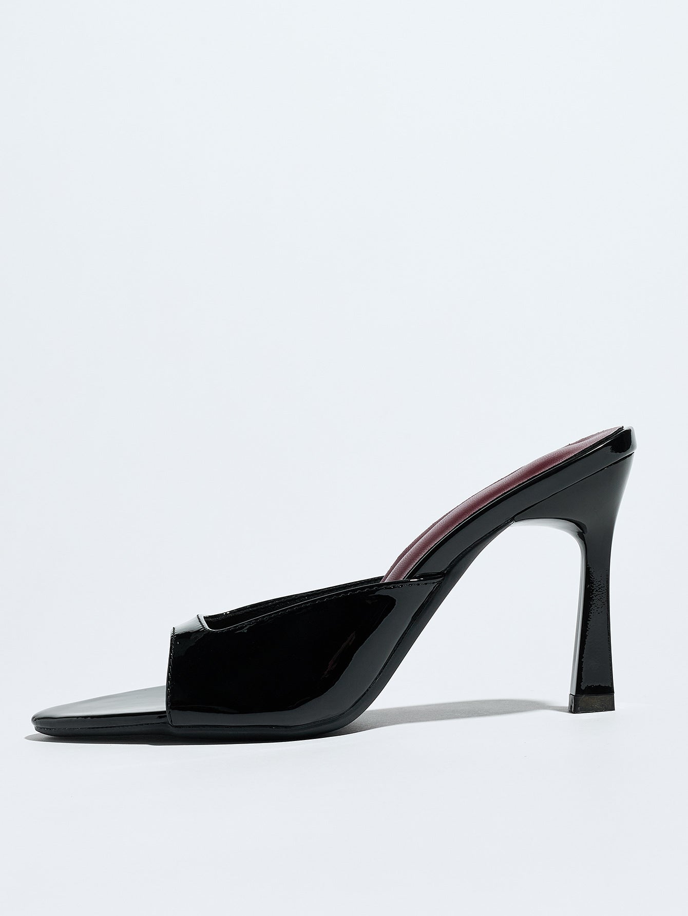 Mescini black square open toe stiletto mules, single shoe in side profile on grey, US women's sizes