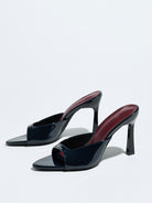 Mescini navy square open toe stiletto mules, pair set at an angle on grey, US women's sizes