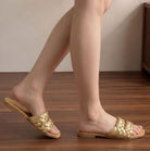 Mescini - gold braided slides worn walking, thin sole edge shown, US women's sizes