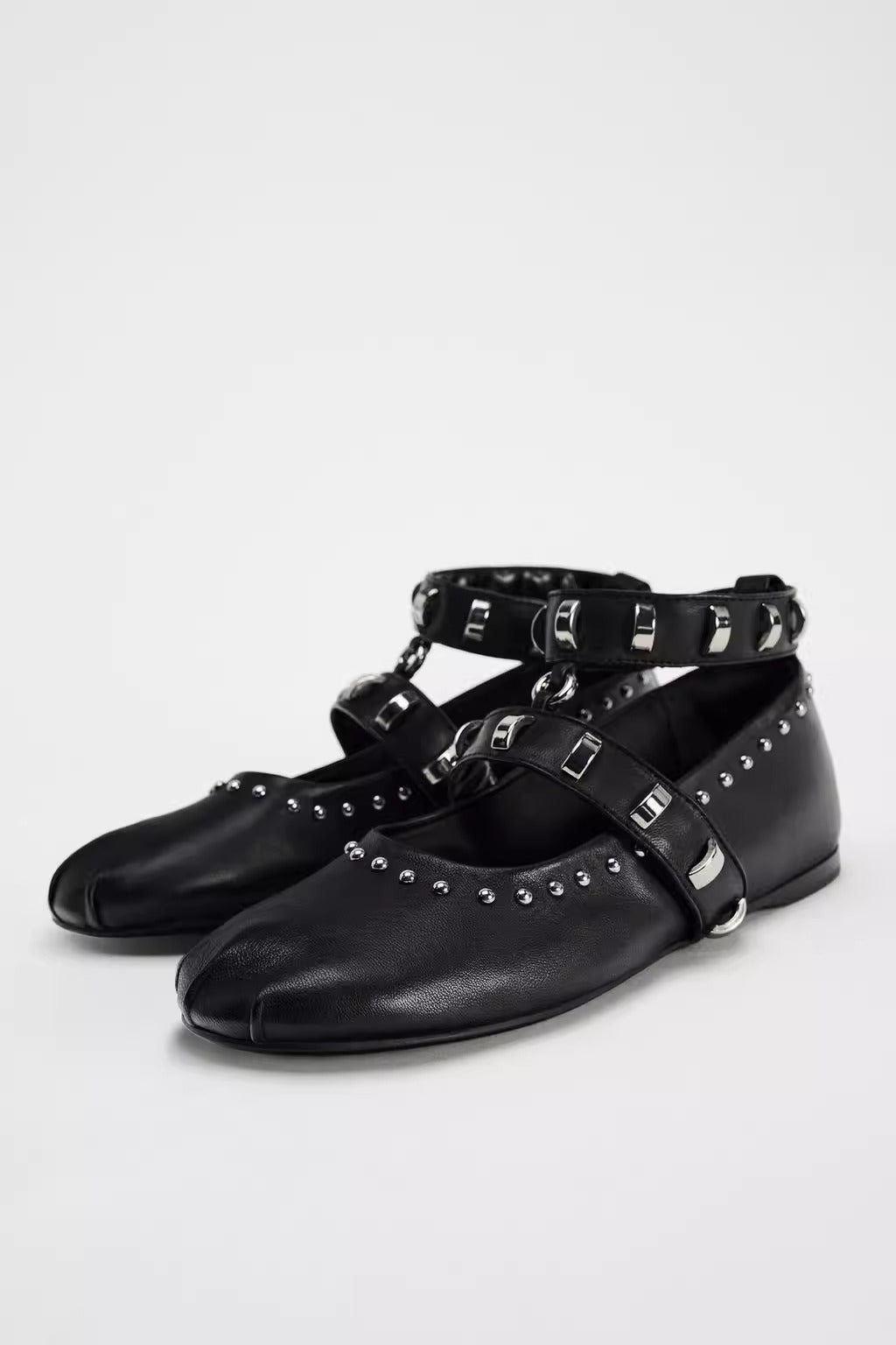 Mescini black studded ankle strap mary jane flats, pair angled on a white ground, US women's sizes