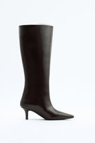 Mescini dark brown pointed toe knee high boots, full side view on a studio backdrop, US sizes