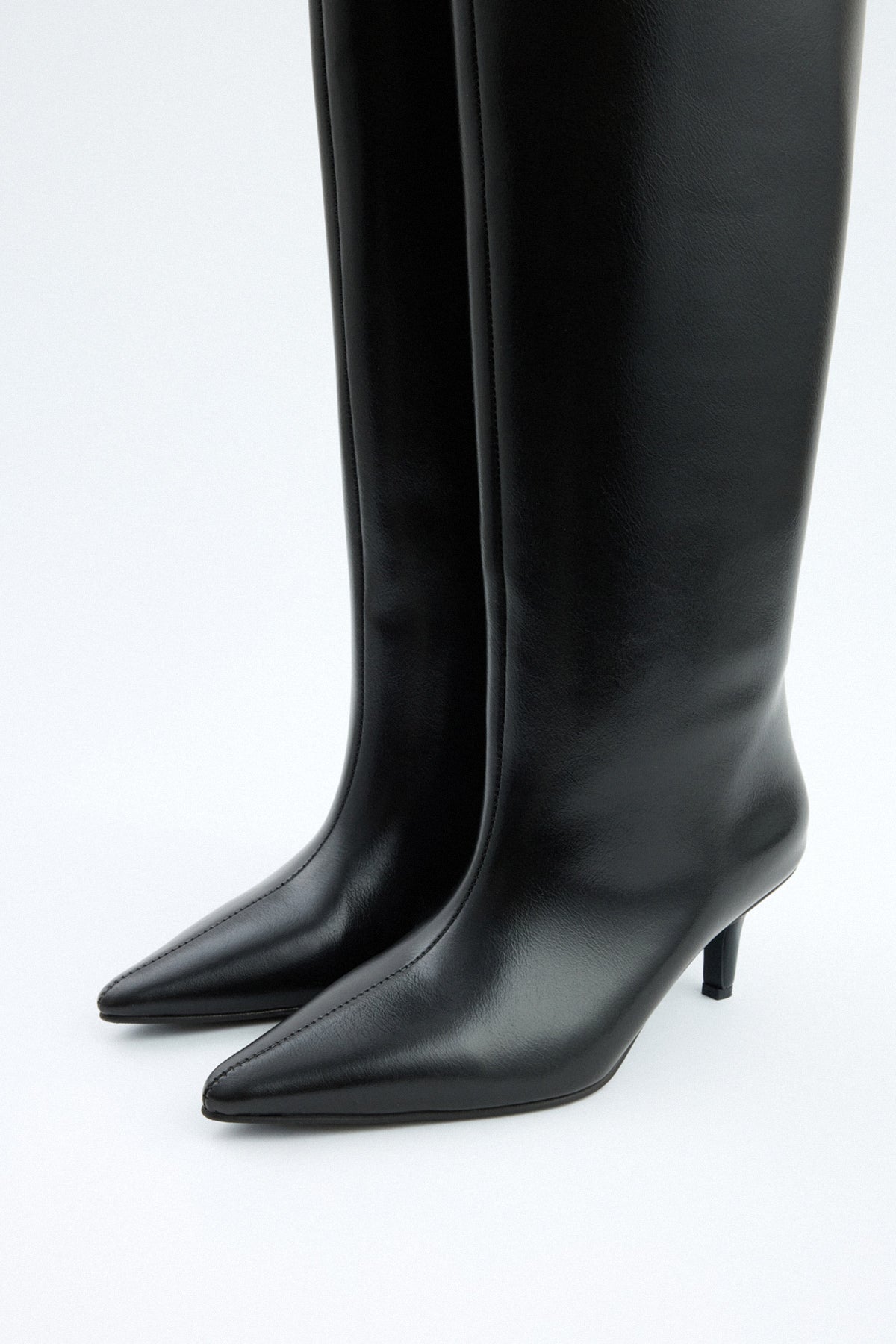 Mescini black pointed toe knee high boots, worn with the shaft standing clear, US sizes