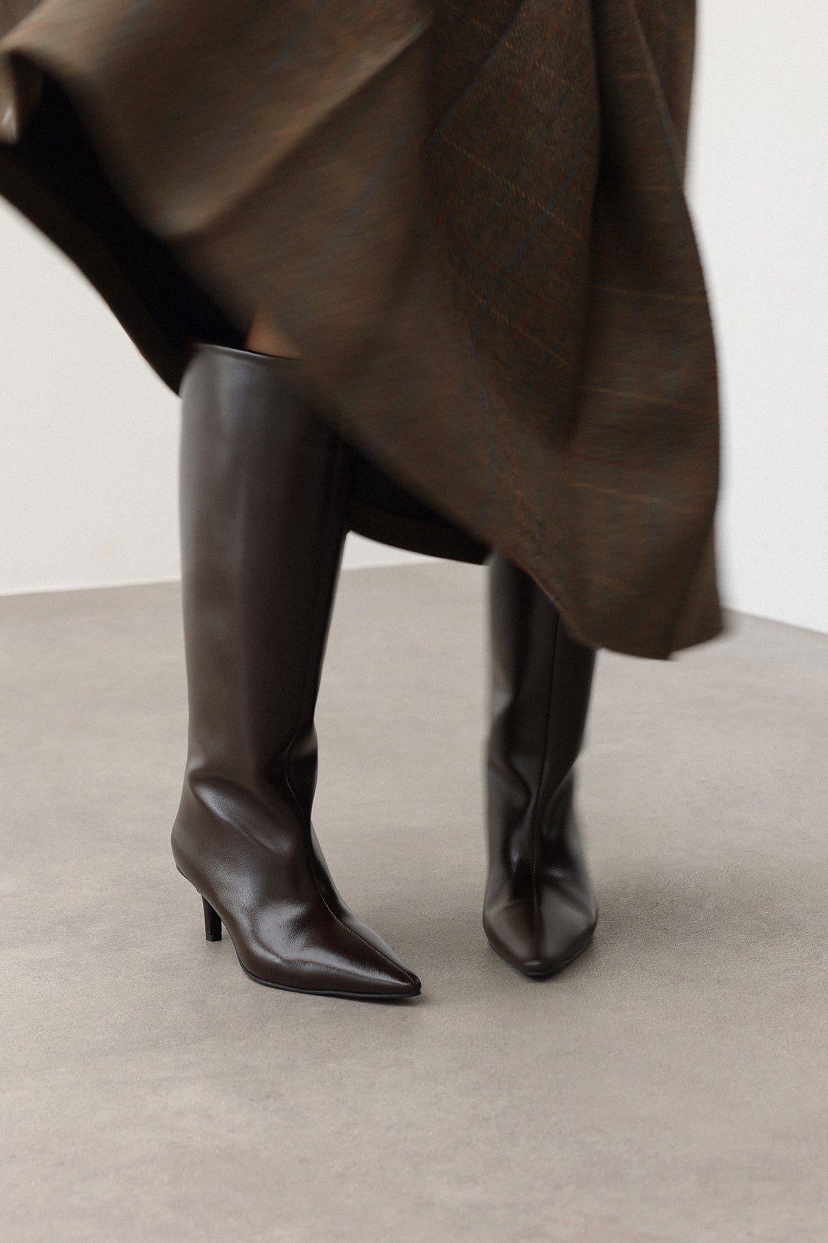 Mescini dark brown pointed toe knee high boots, worn on the leg under a long skirt, US sizes