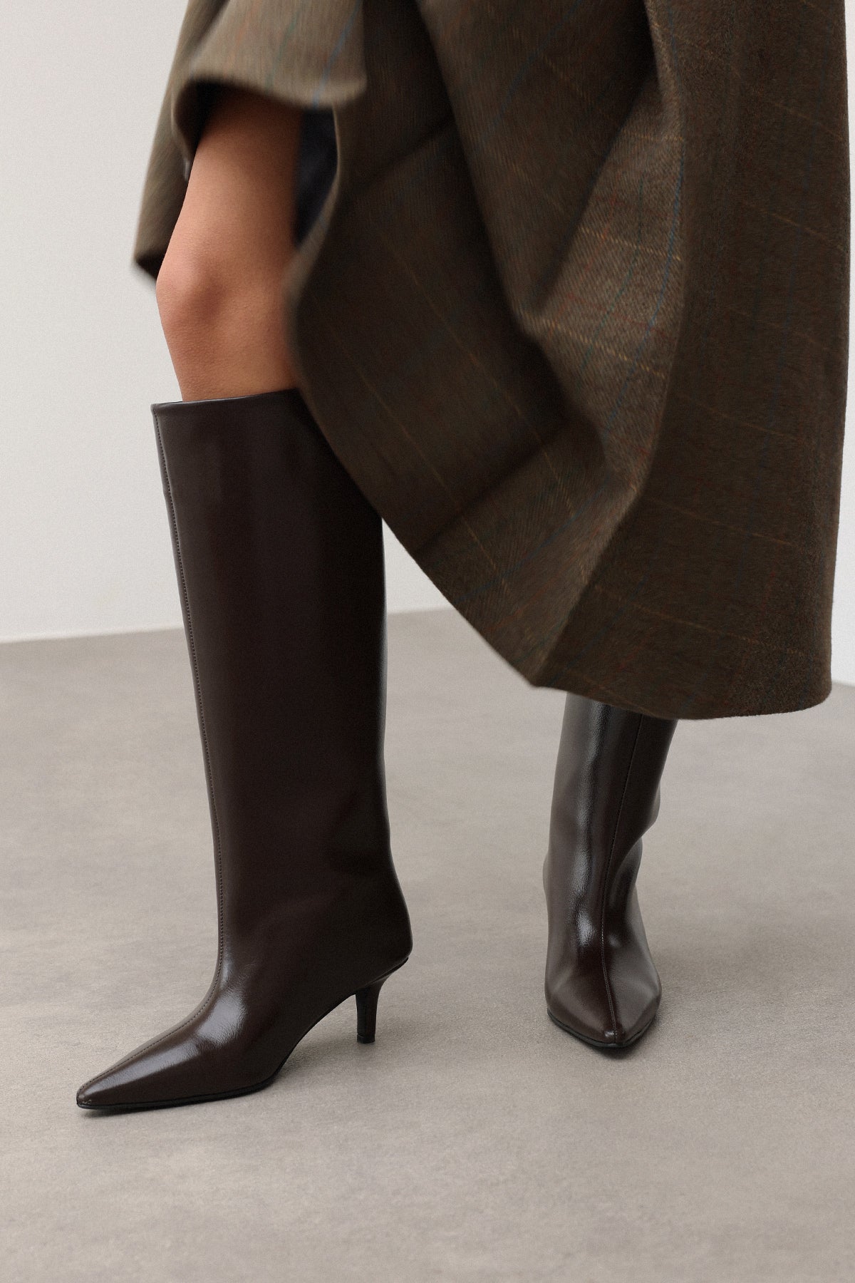 Mescini dark brown pointed toe knee high boots, worn with the shaft standing clear, US sizes