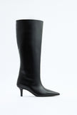 Mescini black pointed toe knee high boots, full side view on a studio backdrop, US sizes