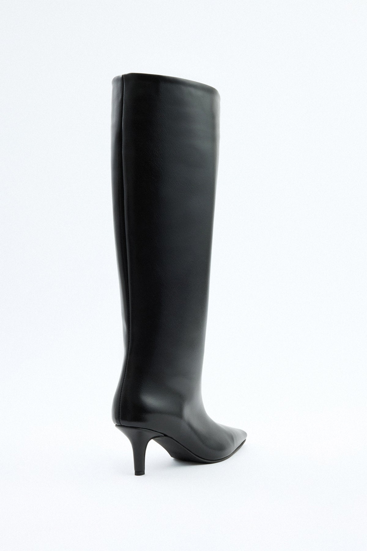Mescini black pointed toe knee high boots, angled pair view on a pale floor, US sizes