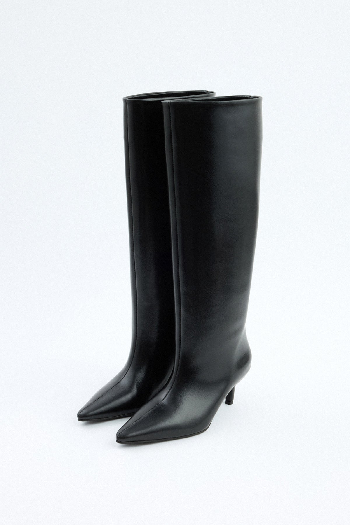 Mescini black pointed toe knee high boots, worn on the leg under a long skirt, US sizes