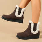 Mescini brown fur trim wedge winter ankle boots, worn on a model against tan, US women's sizes