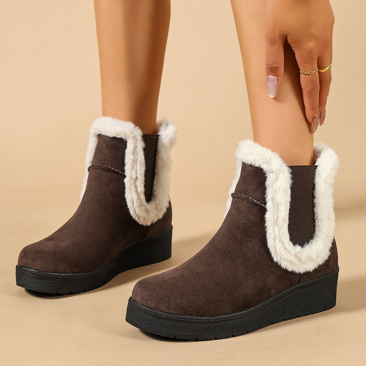 Mescini brown fur trim wedge winter ankle boots, worn as the model reaches down, US women's sizes