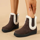 Mescini brown fur trim wedge winter ankle boots, worn as the model reaches down, US women's sizes