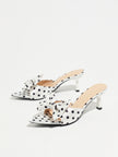 Mescini white polka dot bow pointed mule heels, pair angled on a pale grey background, US women's sizes