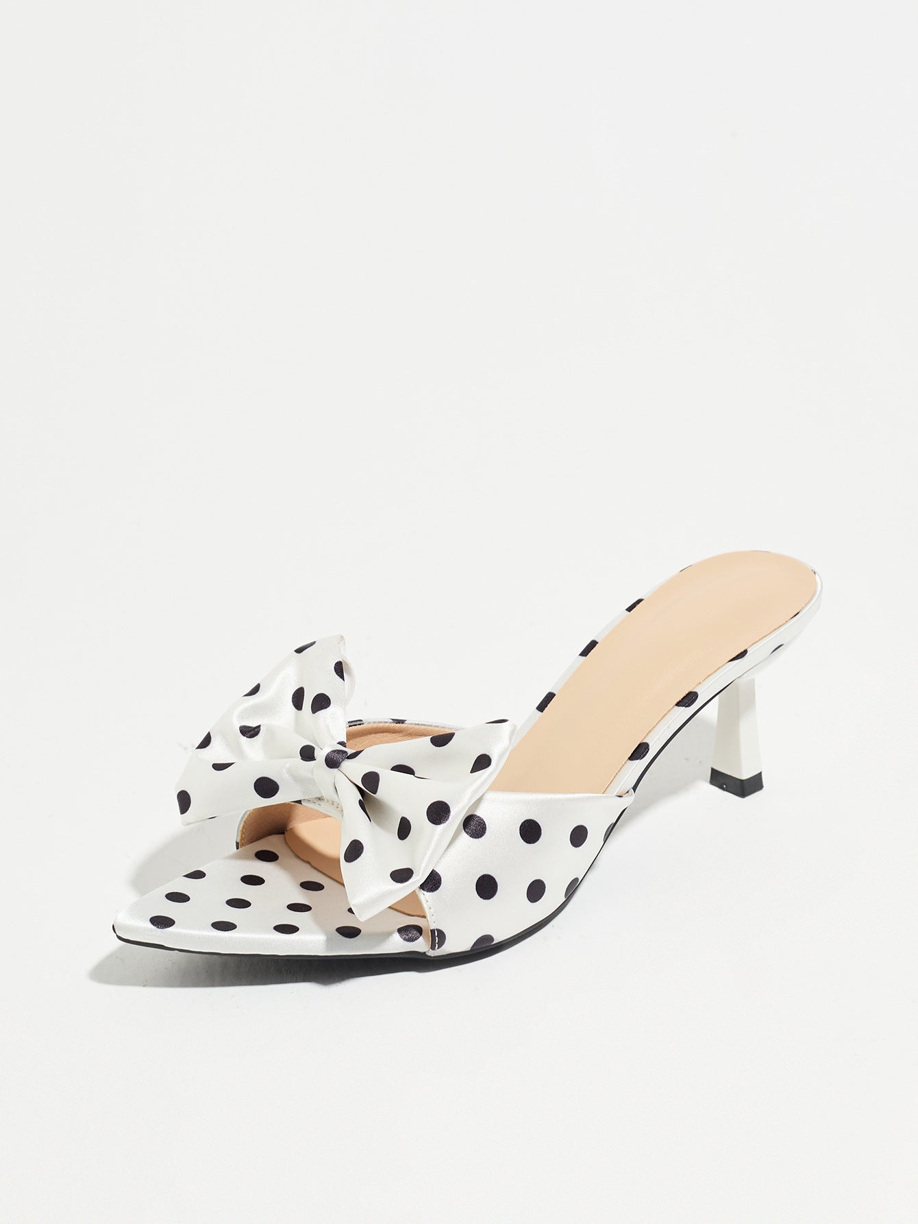 Mescini white polka dot bow pointed mule heels, single shoe seen from the inner side, US women's sizes