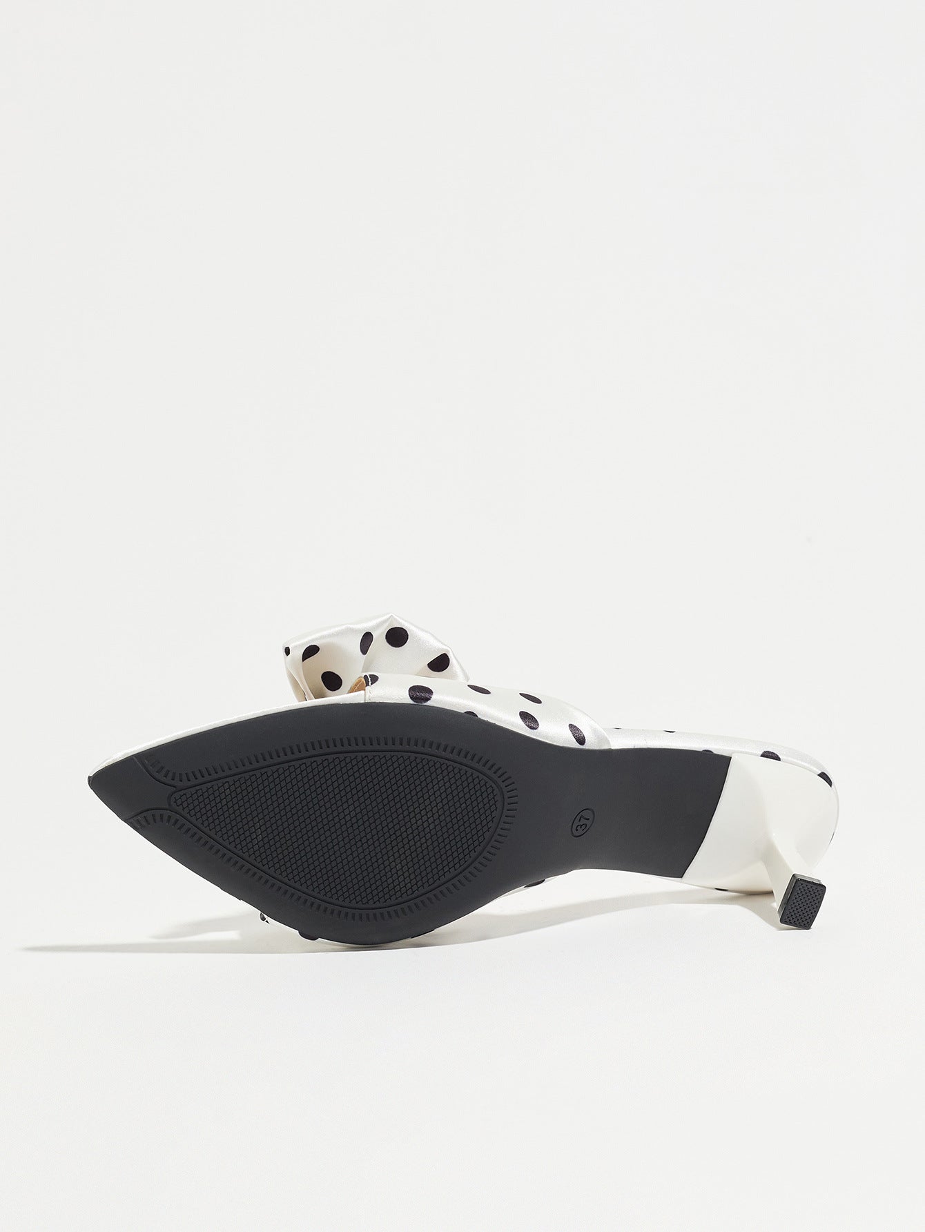 Mescini white polka dot bow pointed mule heels, underside view showing the black sole, US women's sizes