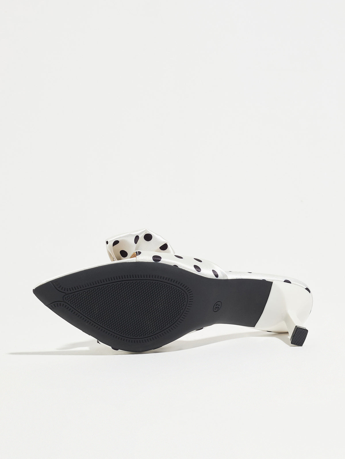 Mescini white polka dot bow pointed mule heels, underside view showing the black sole, US women's sizes