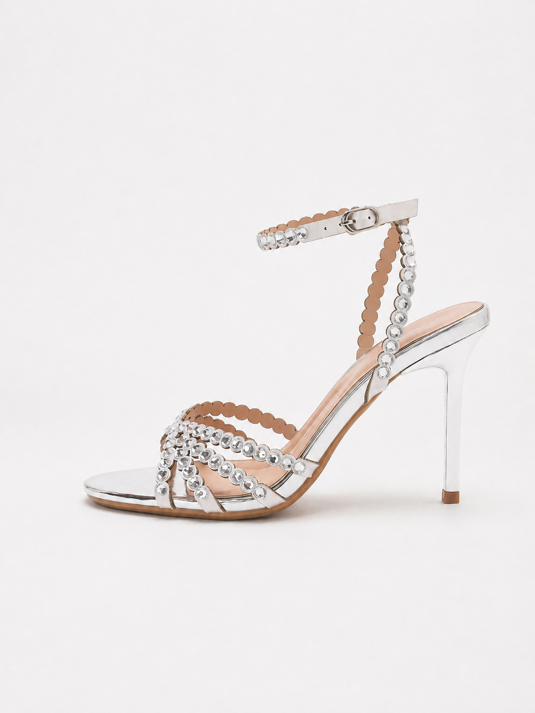 Mescini silver rhinestone strappy stiletto sandals, single shoe seen from the side on white, US women's sizes