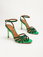 Mescini green rhinestone strappy stiletto sandals, pair angled together on a cream backdrop, US women's sizes