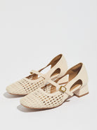 Mescini white woven square toe mary jane heels, pair angled on a pale backdrop, US women's sizes