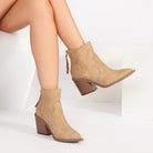 Mescini beige pointed toe western ankle boots, worn while seated, side profile, US women's sizes