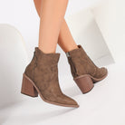 Mescini brown pointed toe western ankle boots, worn feet together, zip pull in view, US women's sizes