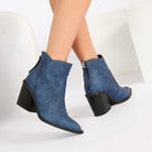 Mescini blue pointed toe western ankle boots, worn standing, zip pull visible, US women's sizes