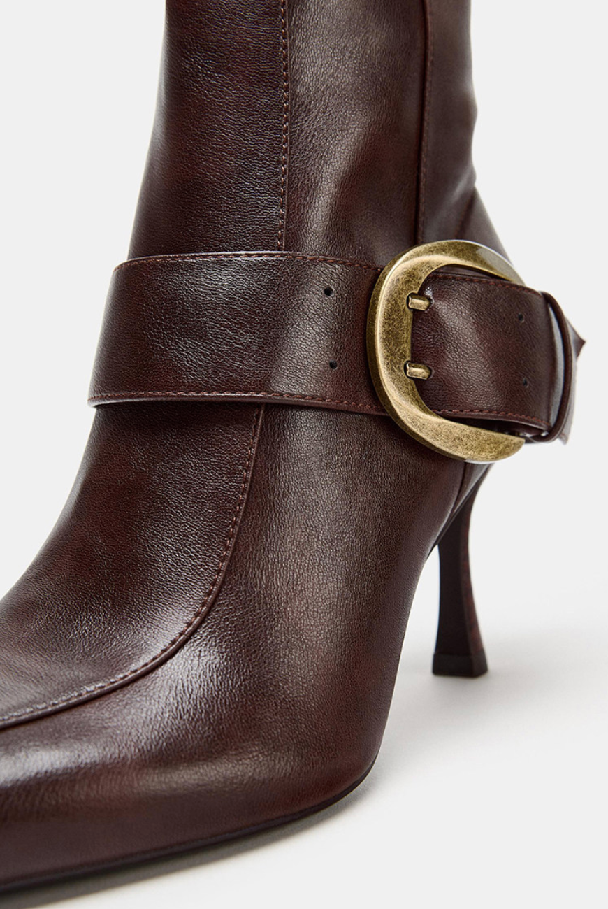 Mescini brown buckled pointed toe knee high boots, close up of the gold hardware, US women's sizes