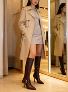 Mescini brown buckled pointed toe knee high boots, worn full length with a trench, US women's sizes