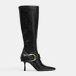 Mescini black buckled pointed toe knee high boots, single shoe at an angle on grey, US women's sizes