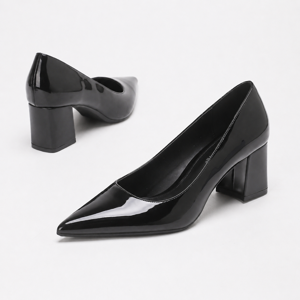 Mescini black high shine pointed toe block heel pumps, the pair angled on a white ground, US women's sizes