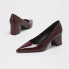 Mescini burgundy high shine pointed toe block heel pumps, pair angled with one shoe tipped, US women's sizes