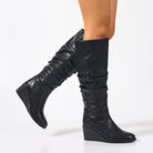 Mescini - black wedge knee high boots on the model, gathered shaft in motion, US women's sizes