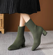 Mescini green knit square toe sock ankle boots, worn mid stride on a grey rug, US women's sizes
