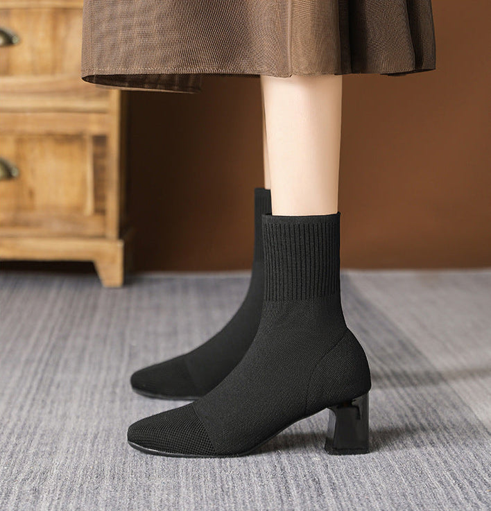 Mescini black knit square toe sock ankle boots, worn standing on a grey rug, US women's sizes
